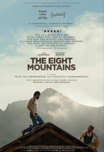 Poster for The Eight Mountains. Two men sit on the roof of a house with mountains in the background.