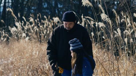 A man and child in a field