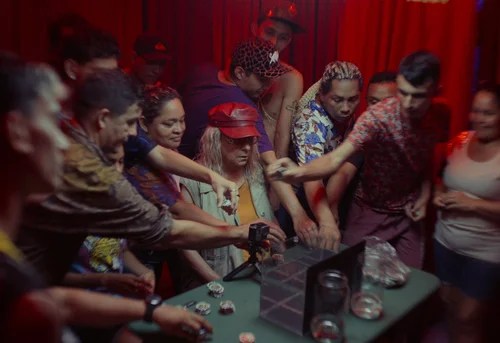 Several people, including an older woman, are gambling